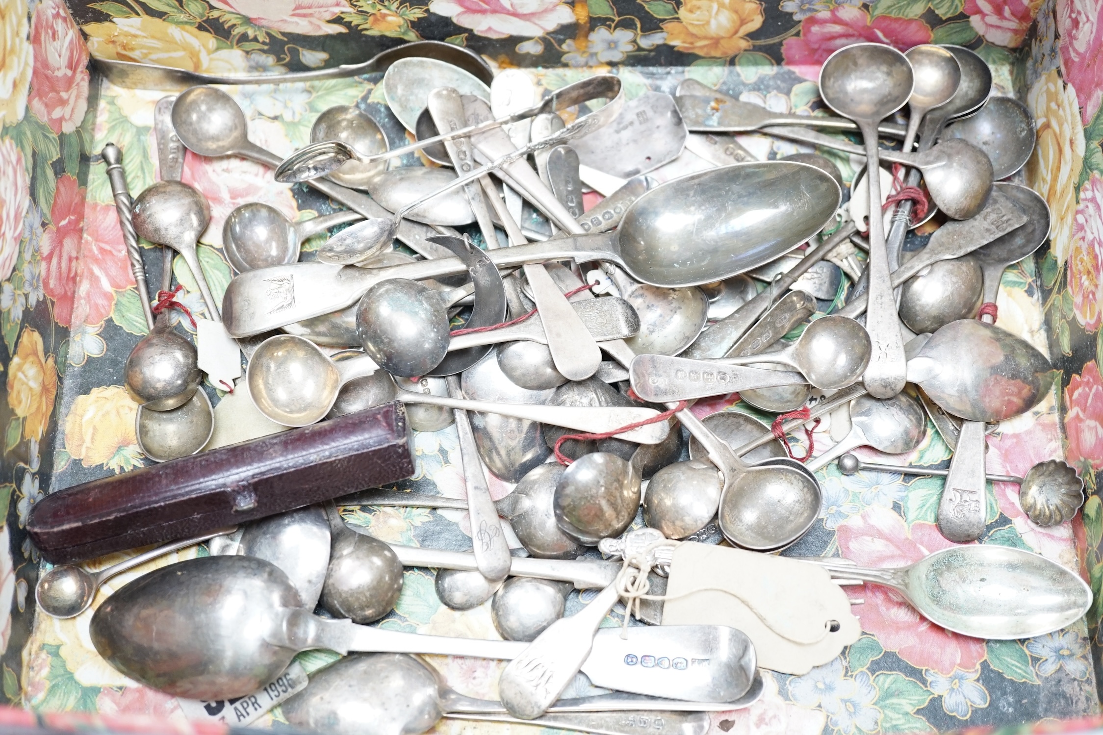 A quantity of mainly 19th century and later silver flatware, including table spoon, dessert spoons, teaspoons, condiment spoons, etc. and other items including two wine labels and a cased 9ct gold mounted amber cigarette